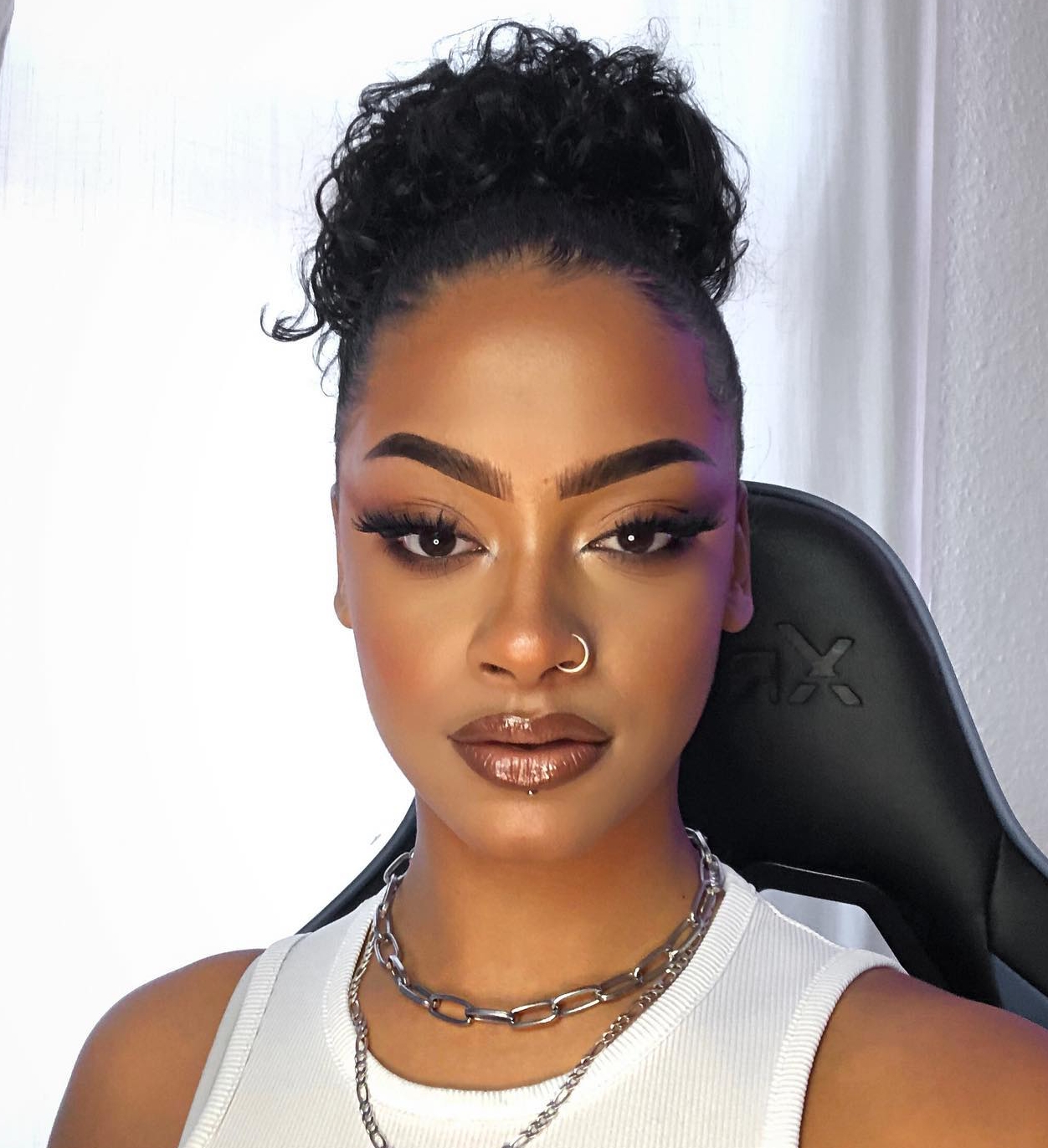 23. Sleek High Bun with a Fluffy Twist