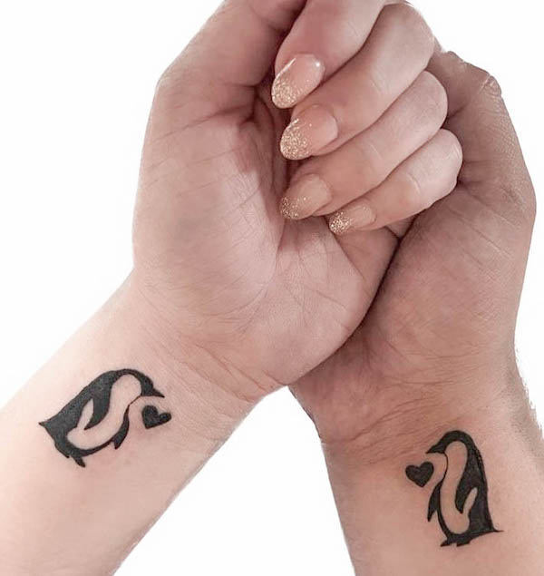 54. Playful Love: Penguin Pair Tattoos for Soulmates