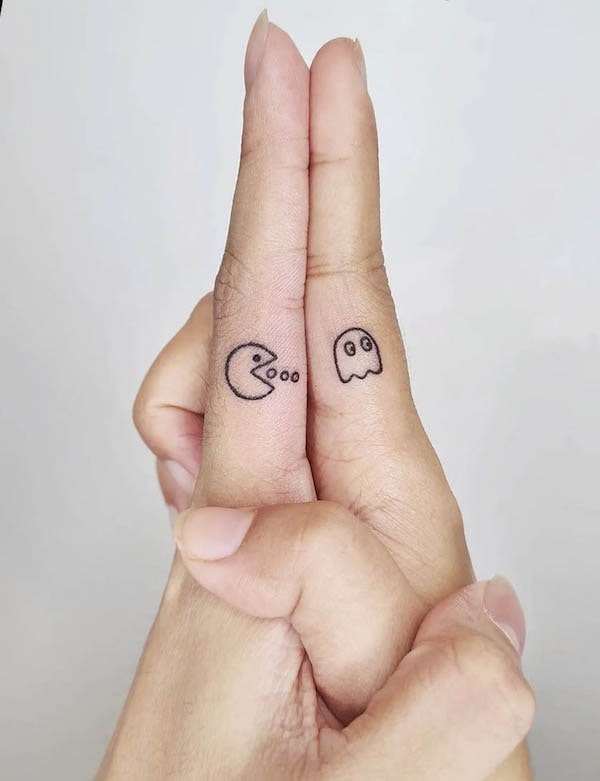 20. Playful Nostalgia: Pac-Man and Ghost Couple Tattoo